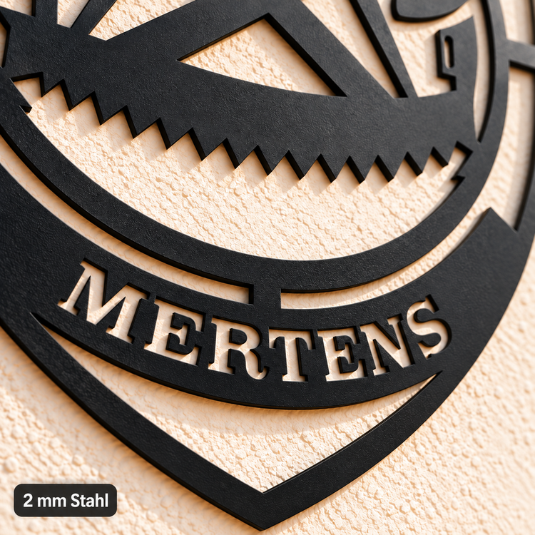 Nahaufnahme der ausgeschnittenen Schrift MERTENS und der offenen unteren Spitze im Zimmerer-Zunftwappen, mit dem Hinweis „2 mm Stahl“.